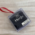 Macro shot of durable black elastic hair bands in a clear gift box with a red ribbon - Black