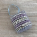 Detail of multi-color elastic braided hair ties in a clear gift box with ribbon - Purple