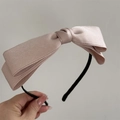 Detailed close-up of pink satin double-layered bow headband with smooth texture - Beige