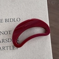 Close-up of a minimalist burgundy crescent hair claw clip with a glossy mirror finish texture - Gold Glitter Red - Crescent Moon