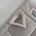 Detail view of triangular cream hair claw clip with golden spring and glossy finish - Slim Triangle-White