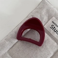 Detailed view of glossy burgundy triangular hair claw on textured linen fabric - Chubby Triangle-Red