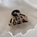 Macro shot of tortoise shell pattern acetate hair claw clip on white shell tray decor - Light Leopard