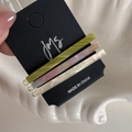 Close-up of three acetate hair clips in olive green, marble pink-blue, and pearl white - Light Green