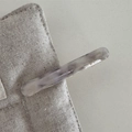 Macro detail of marble pattern acetate barrette with Barrette la France logo text - Mermaid Gradient