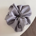 Detail of lavender satin oversized scrunchie with silk sheen and handmade woven label - Gray