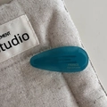 Detail of teal acetate teardrop hair clip with France Handmade gold engraving - Cyan