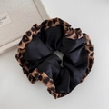 Detailed view of leopard print and black satin dual-design large hair scrunchie accessory - Black With Leopard Edge