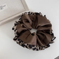 Close-up of a large satin scrunchie featuring dark brown fabric and leopard print edges - Coffee With Leopard Edge