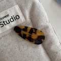 Detailed macro view of acetate teardrop hair clip with France Handmade gold lettering - Tortoiseshell