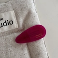 Detail view of purple acetate water-drop hair clip with France Handmade gold lettering - Rose Red