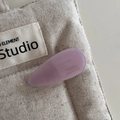 Close-up of a matte lavender teardrop acetate hair clip with gold handmade engraving - Light Pink