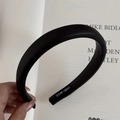 Detailed close-up of a thick black leather headband featuring a handmade inner label - Black (Soft Leather Headband)
