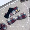 Detailed view of red and blue plaid bow hair clips with classic vintage preppy style fabric - Red Green Plaid Pair Clips