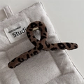 Close-up of leopard print fabric claw clip with soft texture and metal spring mechanism - Leopard Fabric Large Hanger Style