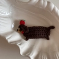Detailed macro of handmade crochet brown dachshund puppy hair clip with red strawberry - Crochet Brown Dog