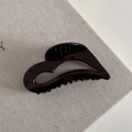 Detailed view of dark chocolate acetate heart hair claw with Barrette La France gold lettering - Coffee