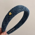 Detail of navy blue plaid headband with a golden heart-shaped metal logo and handmade label - Blue