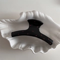 Close-up of a glossy black hair claw clip featuring red polka dots on a shell plate - Black Red Polka Dot Straight Bar Style