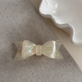 Detail of a handmade double-layered acetate bow hair clip with pearlescent shell finish - Off White