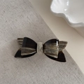 Macro detail of marble pattern acetate hair clip with gold France Handmade text engraving - Marble