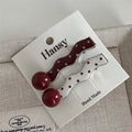 Detail of red and white polka dot wavy hair clips with beads on a branded card - Red White Polka Dot - Wave
