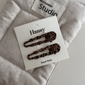 Set of two vintage leopard print duckbill hair clips displayed on a soft fabric pouch - Hollow Style