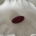 Close-up of retro burgundy hair clip with cream polka dots on a white tray - Red Polka Dot - Oval