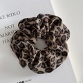 Detail of wide leopard print scrunchie with twill fabric texture on book background - Scrunchie / Apricot Leopard