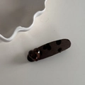 Detail of dark brown leopard bow hair clip with amber heart accent on white surface - Dark Coffee Leopard Oval Duckbill Clip