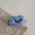 Detailed close-up of blue wool yarn heart hair clip with handmade texture on card - Light Blue