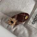 Detail of a brown plaid hair clip featuring a knitted flower and gold Love metal tag - Coffee Checkered Velvet Surface - Oval BB Clip