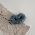 Detailed view of plush teal yarn heart hair clip with fluffy mohair texture finish - Cyan
