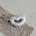 Close-up of white knitted heart hair clip on decorative paper with metal duckbill clip - White