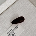 Detail of a dark reddish-brown acetate hair clip with France Handmade engraving - Dark Coffee