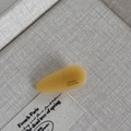 Detailed macro view of handmade amber acetate hair clip with French handmade engraving - Yellow