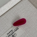 Macro detail of magenta acetate hair clip with FRANCE handmade engraving on linen - Rose Red