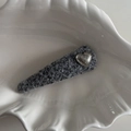 Detail of gray tweed BB hair clip with silver heart charm on white shell prop - Hammered Silver Heart Silver Gray Triangle BB Clip