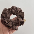 Close-up of dark brown pleated satin scrunchie with a gold 'HAND MADE' metal tag - Dark Coffee