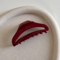 Detail of dark red acetate hair claw clip showing the gold France Handmade engraving - Hollow Dumpling Shape / Small Red
