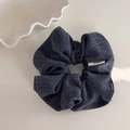 Detail of dark blue striped scrunchie with white stitching and retro denim texture - Blue