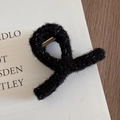 Detail of black fuzzy hair claw with silver glitter and golden metal spring mechanism - X-Shape Crossed (Black with Tinsel)