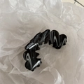 Detail of a wavy black and white marble hair claw clip on white crinkled paper - Wave Sawtooth Flower - Black