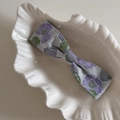 Detail van een vintage haarspeld met paarse bloemen op een wit keramisch schelpenbakje - Monet Paarse Bloem Grote Strikclip