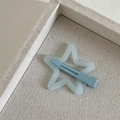 Close-up of a matte light blue star-shaped hair clip on a canvas texture tray - Dopamine Star-Blue