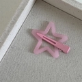 Detail shot of a matte pink star-shaped hair clip on a textured display tray - Dopamine Star-Rose Pink