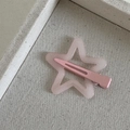 Detailed view of a pink star hair clip with glitter resin on a soft textured fabric tray - Dopamine Star-Pink