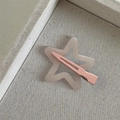 Macro shot of gray translucent star hair clip with pink metal beak clip on fabric - Dopamine Star-Light Pink