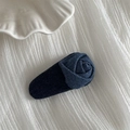 Detailed view of a dark blue denim fabric rose flower hair clip on white textured cloth - Dark Denim Rose Teardrop BB Clip