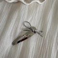 Close-up of a silver thin rope bow hair clip on a textured white fabric background - Silver Clip - Silver Bow